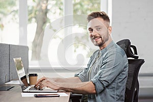 Man journalist working on computer. Businessman using laptop in office.