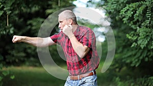 A man juggles with an imaginary opponent. Shadow fight training