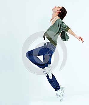 Man, jump and dance in the air for happiness with action, movement and balance of body isolated on white studio