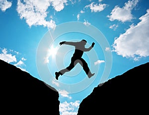 Man jump through the gap. photo