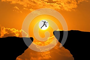 Man jump through the gap between hill.man jumping over cliff