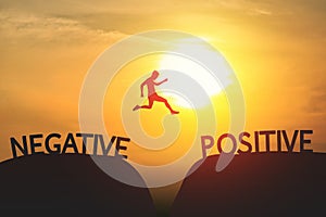A Man jump through the gap between Negative to Positive on sunset