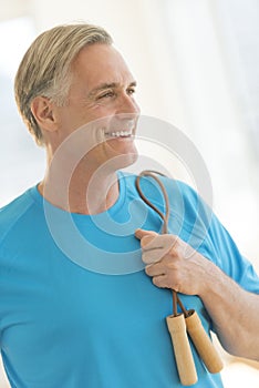 Man With Jump Rope Looking Away In Gym