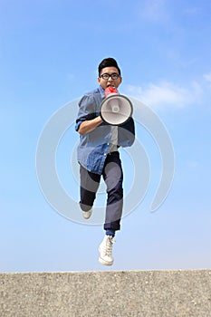 Man jump and shout megaphone