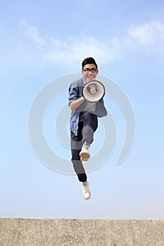 Man jump and shout megaphone