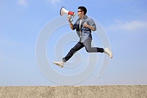 Man jump and shout megaphone photo