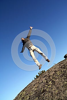 Man jumping with arms wide open