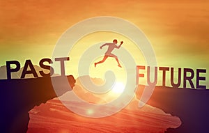 Man jumping on cliff Future. Silhouette man jumping between cliff with Past to Future on sunset background. Goals, hopes and