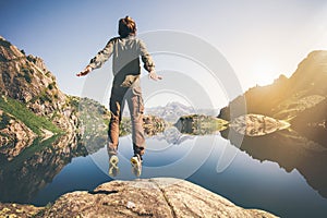 Man jumping Flying levitation with lake and mountains on background