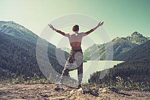 Man jumping Flying levitation with lake and mountains on background Lifestyle Travel happy emotions concept outdoor. Tourist sprea