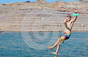 Man jumping in a lake.