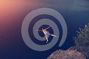 Man jumping into the lake from cliff