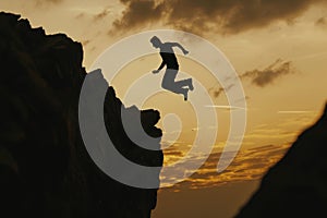 Man Jumping off Cliff Into Air