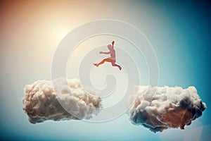 Man jumping from one cloud to another. Challenge.
