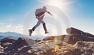 Man jumping over gap on mountain hike