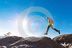 Man jumping over gap on mountain hike