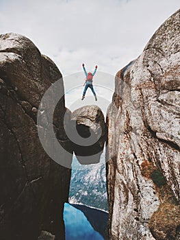 Man jumping over Kjeragbolten Travel in Norway