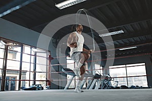 Man With Jumping Rope On Boxing Ring. Asian Male Bodybuilder Using Gym Equipment For Workout.