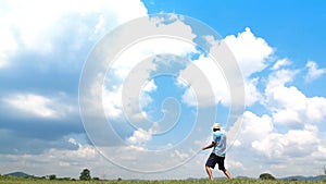 A man jumping slow motion and cloud sky background.