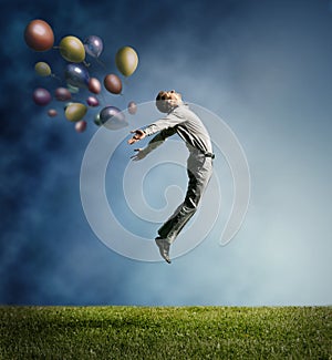 Man jumping up to Sky wit color bright balloon