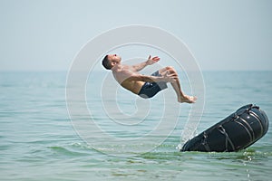 Man jumps from an inflated camera into the sea