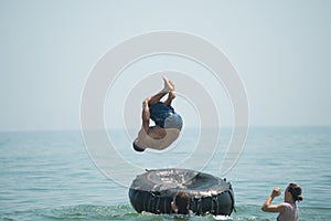 Man jumps from an inflated camera into the sea