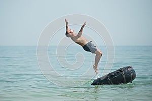 Man jumps from an inflated camera into the sea