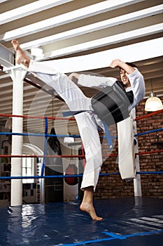 Man, karate and high kick in training, self defense or jiujitsu for martial arts or fighting match. Male person, athlete