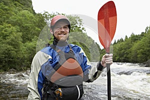 Man With Kayak Oar Against River