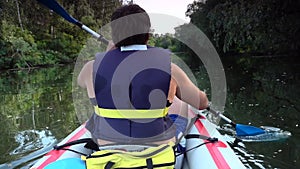 Man on kayak swim on big river. Slow motion