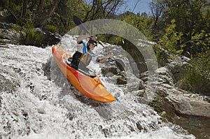 Man Kayaking On Mountain River