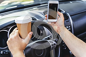 Man keeping cellphone and driving his car