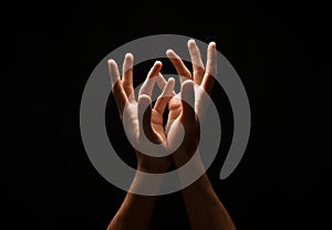 Man keeping hands in cupped shape, cutout on black