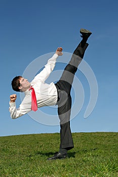 Man kicking in Kung Fu pose photo