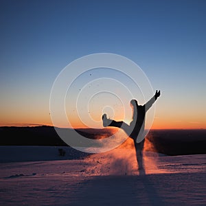 Man kicking snow in winter landscape