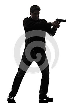 Man killer policeman aiming gun standing silhouette