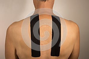 Man with Kinesio Tape on his back for pain