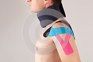 Man with kinesiotaping on the shoulder