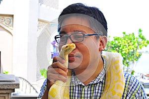 Man kiss an albino snake