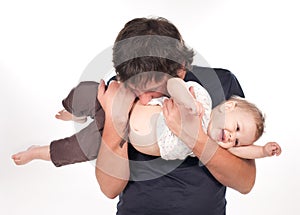 Man kisses his baby on white