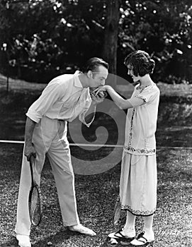 Man kissing the hand of a woman