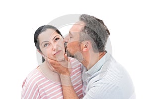 Man kissing woman cheek