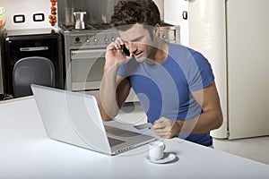 Man in the kitchen with laptop