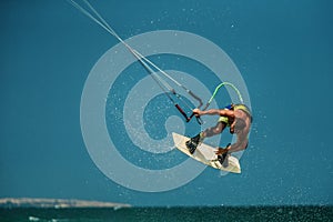 Man Kitesurfing in blue sea