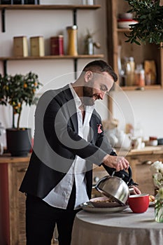 Man on the kithen make tea, cooking and smile photo