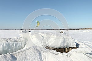 Man is kiting on skis on the frozen river