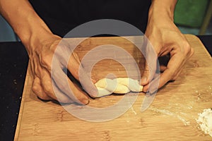 Man kneading raw donut dough