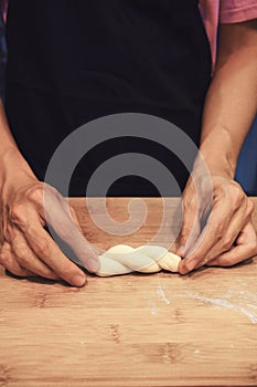 Man kneading raw donut dough