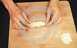 Man kneading raw donut dough