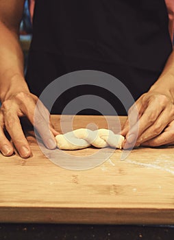 Man kneading raw donut dough